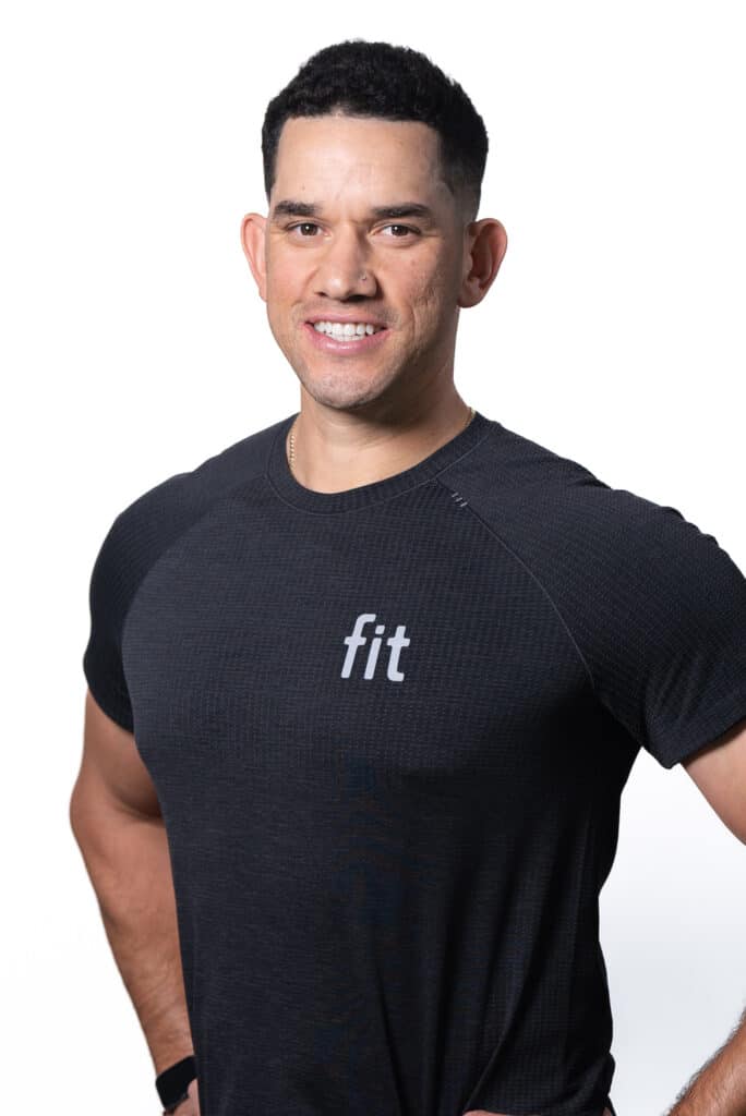 A man in a black t - shirt is posing for a photo.