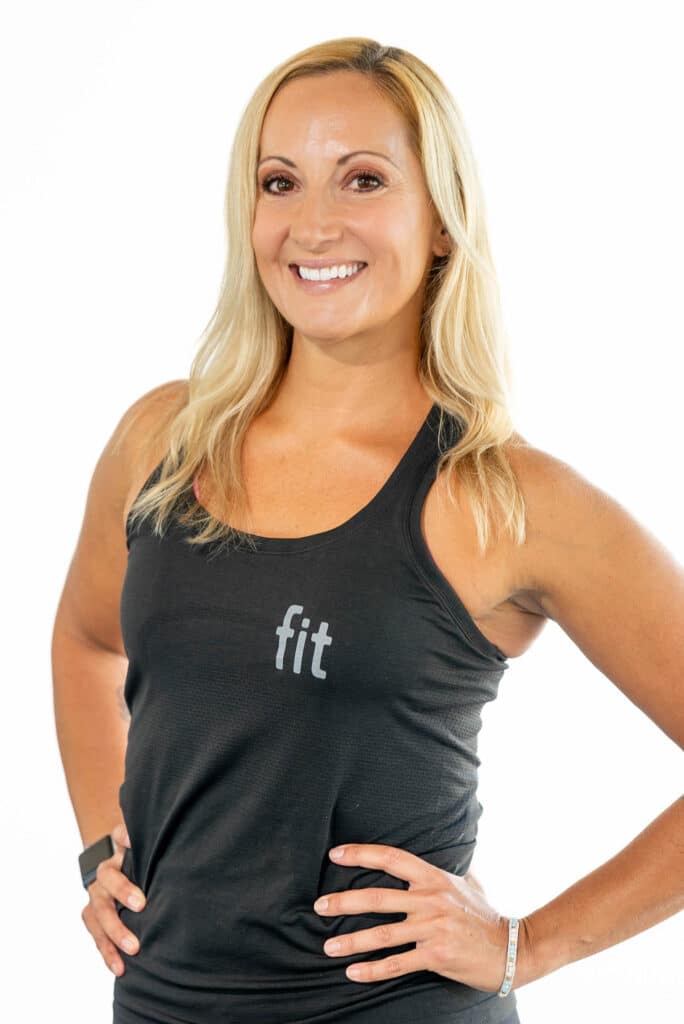 A woman in a black tank top posing for a photo.