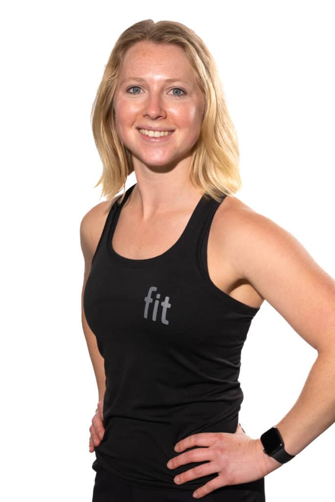 A woman in a black tank top posing for a photo.