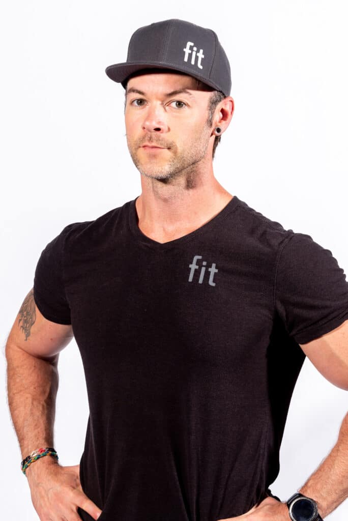 A man wearing a black v - neck t - shirt and black hat.