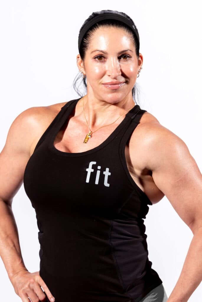 A woman in a black tank top posing for a photo.