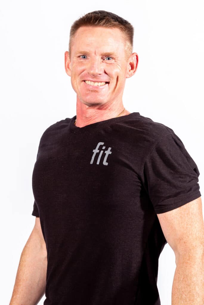 A man wearing a black t - shirt smiling.
