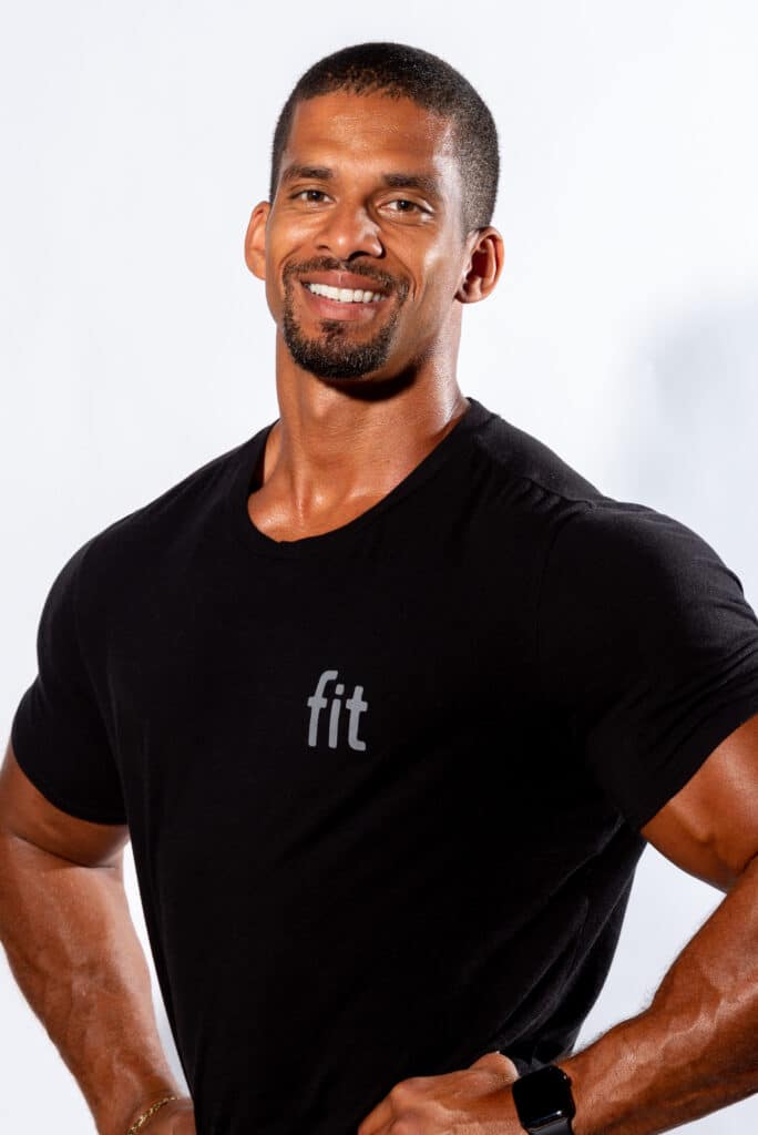 A man in a black t - shirt posing for a photo.