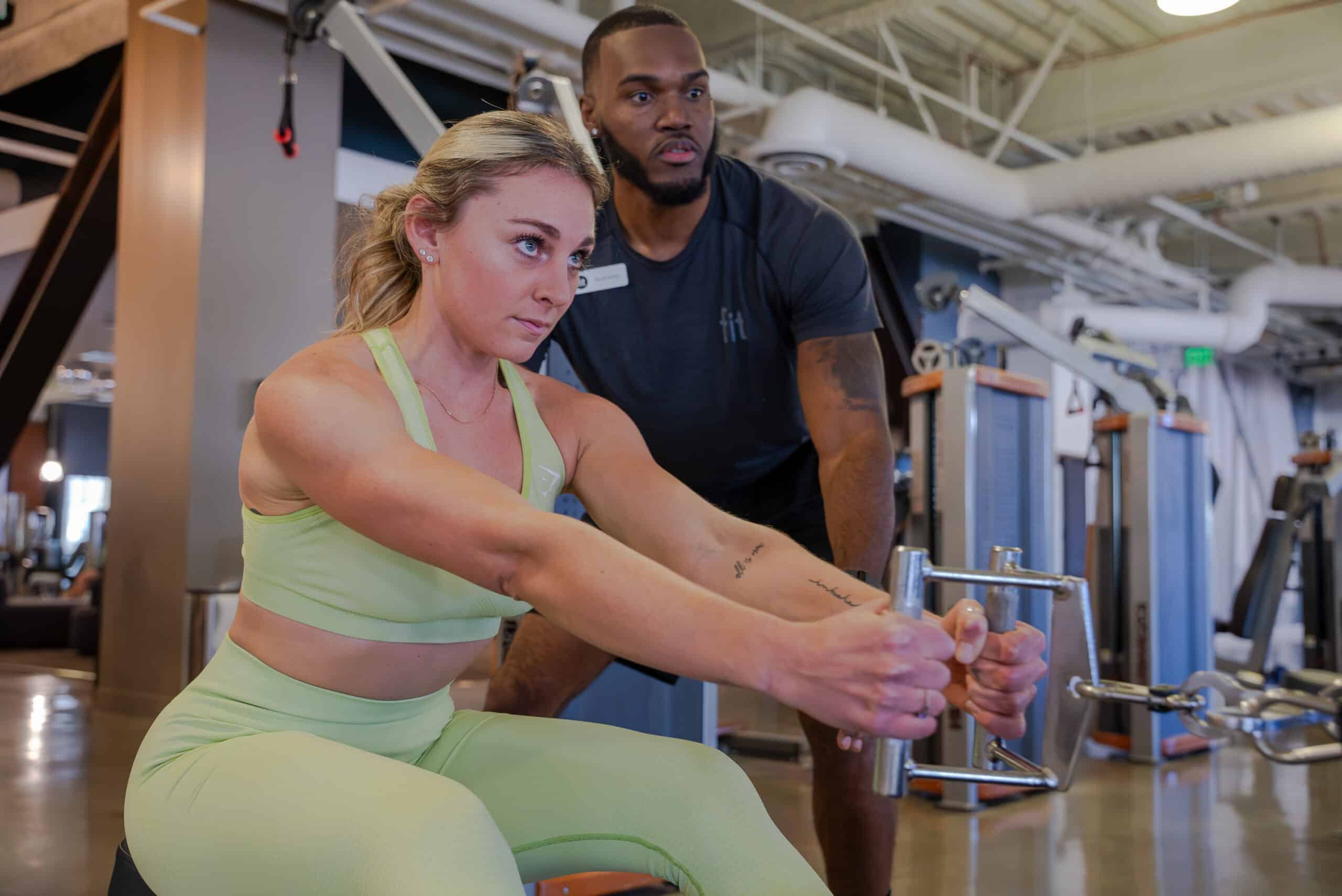 A man and woman working out in a gym.